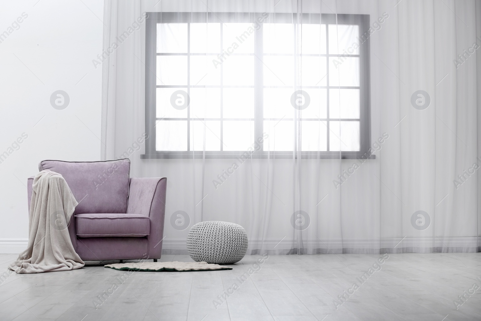 Photo of Stylish comfortable armchair near window