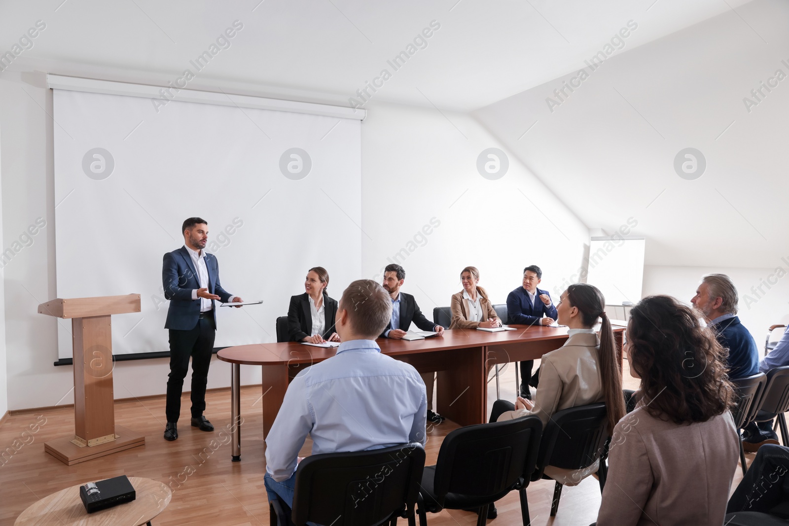 Photo of Business conference. People in meeting room listening to speaker report