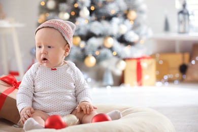 Little baby wearing cute hat indoors. First Christmas