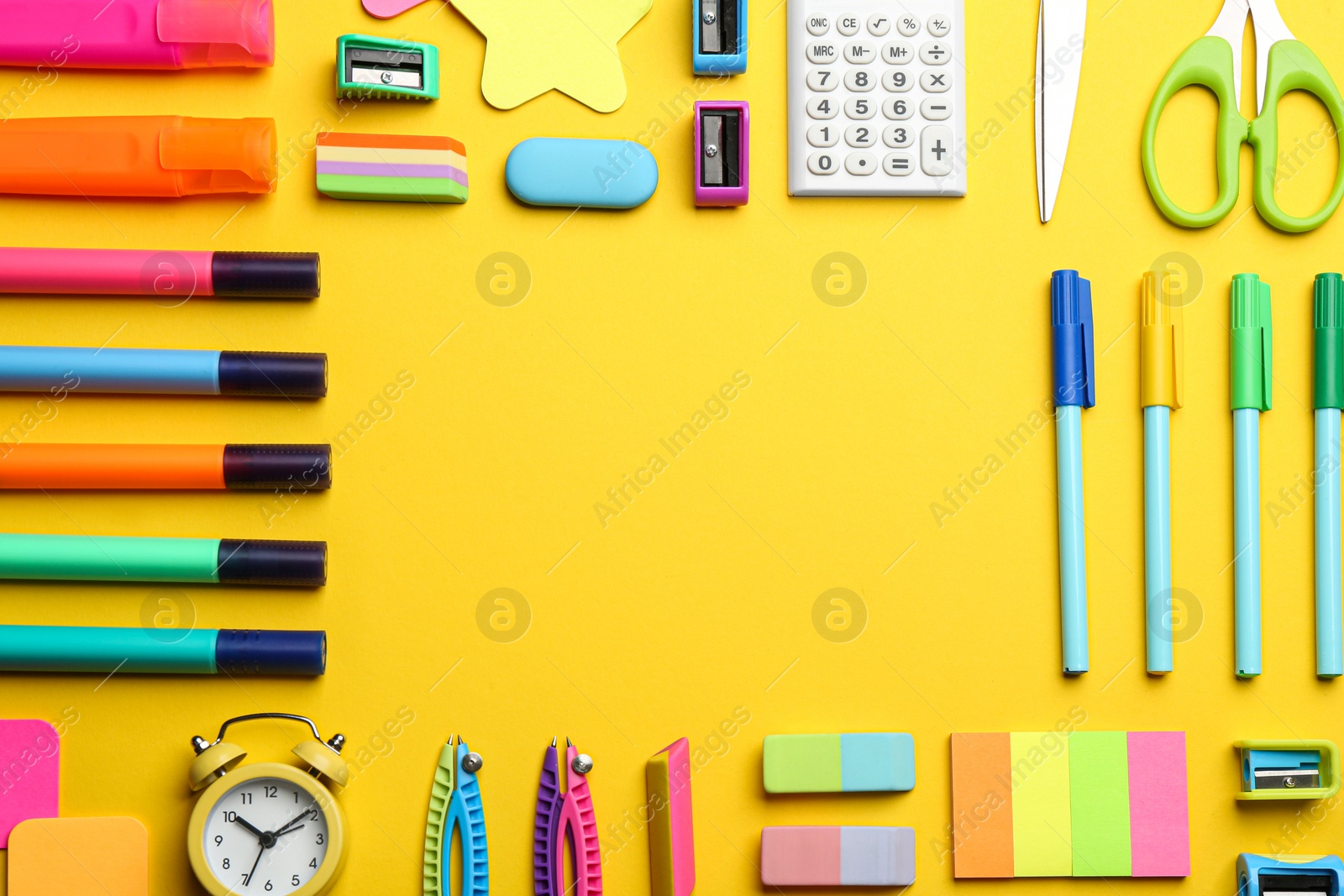 Photo of Frame of different school stationery on yellow background, flat lay with space for text. Back to school