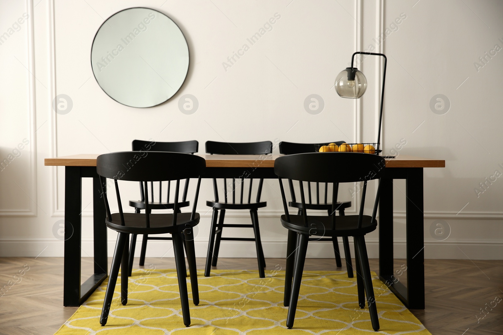 Photo of Stylish wooden dining table and chairs in room. Interior design