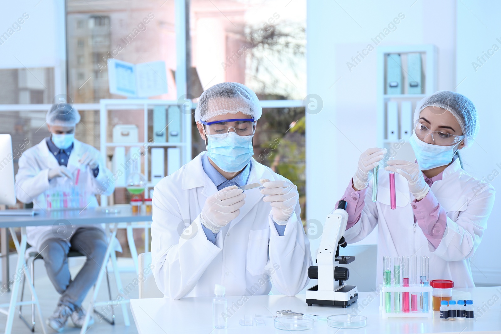 Photo of Young scientists working in laboratory. Chemical analysis