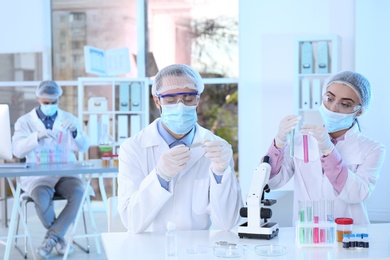 Young scientists working in laboratory. Chemical analysis