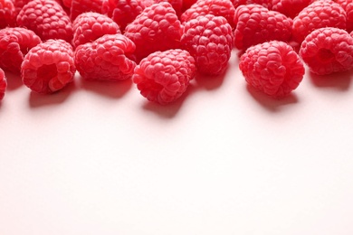 Photo of Fresh sweet ripe raspberries on pink background. Space for text