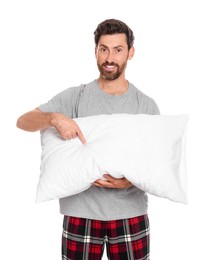 Photo of Handsome man pointing on soft pillow against white background