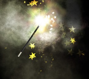 Magic wand and enchanted stars on dark background