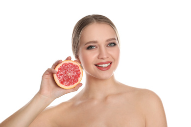 Young woman with cut grapefruit on white background. Vitamin rich food