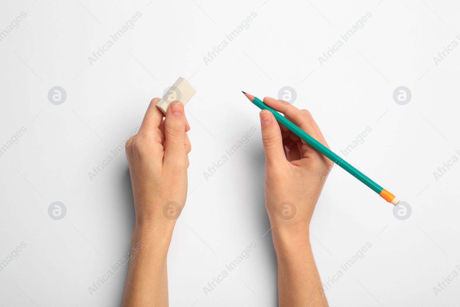 Photo of Woman with graphite pencil and eraser on white background, top view