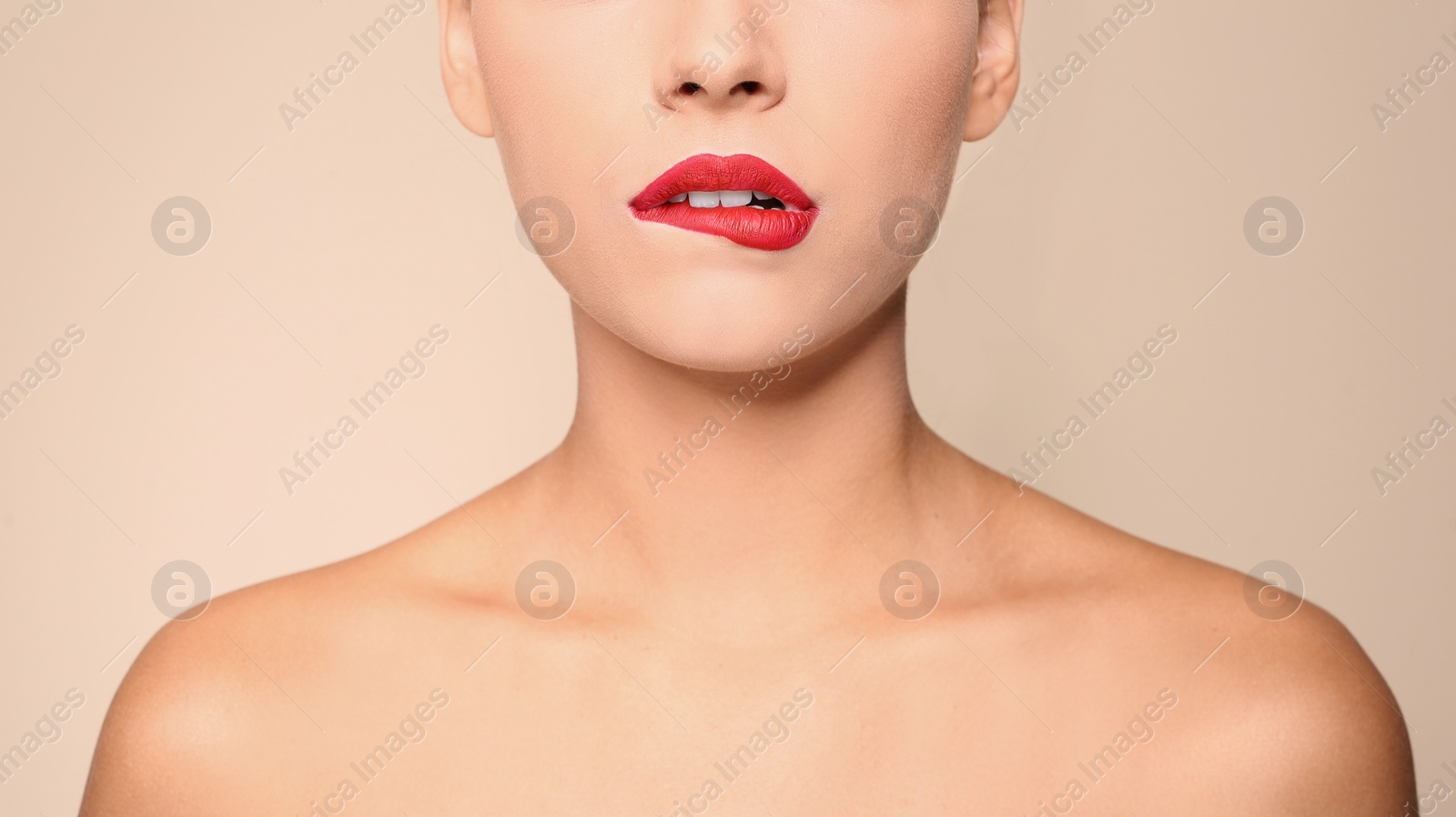 Photo of Beautiful young woman with red lips on color background, closeup