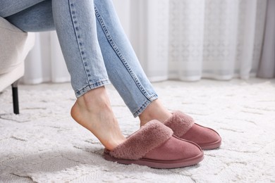 Photo of Woman in soft slippers at home, closeup