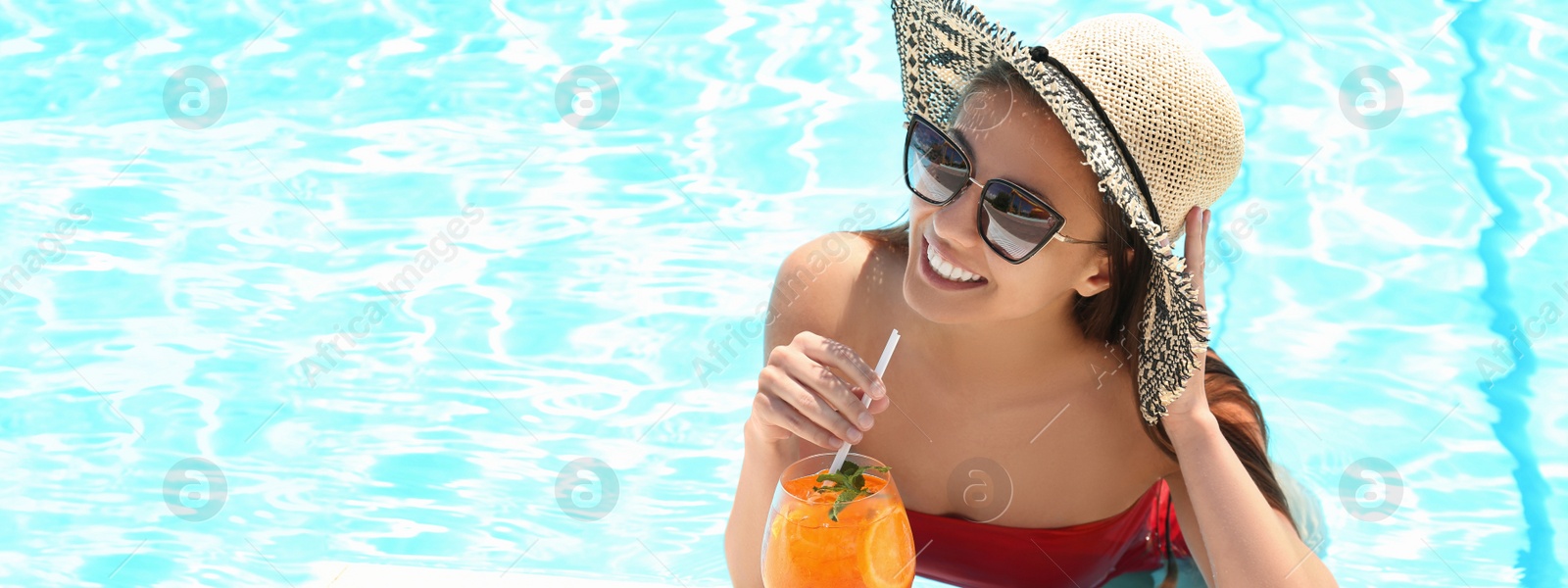 Image of Woman with glass of refreshing drink in swimming pool on sunny day, banner design