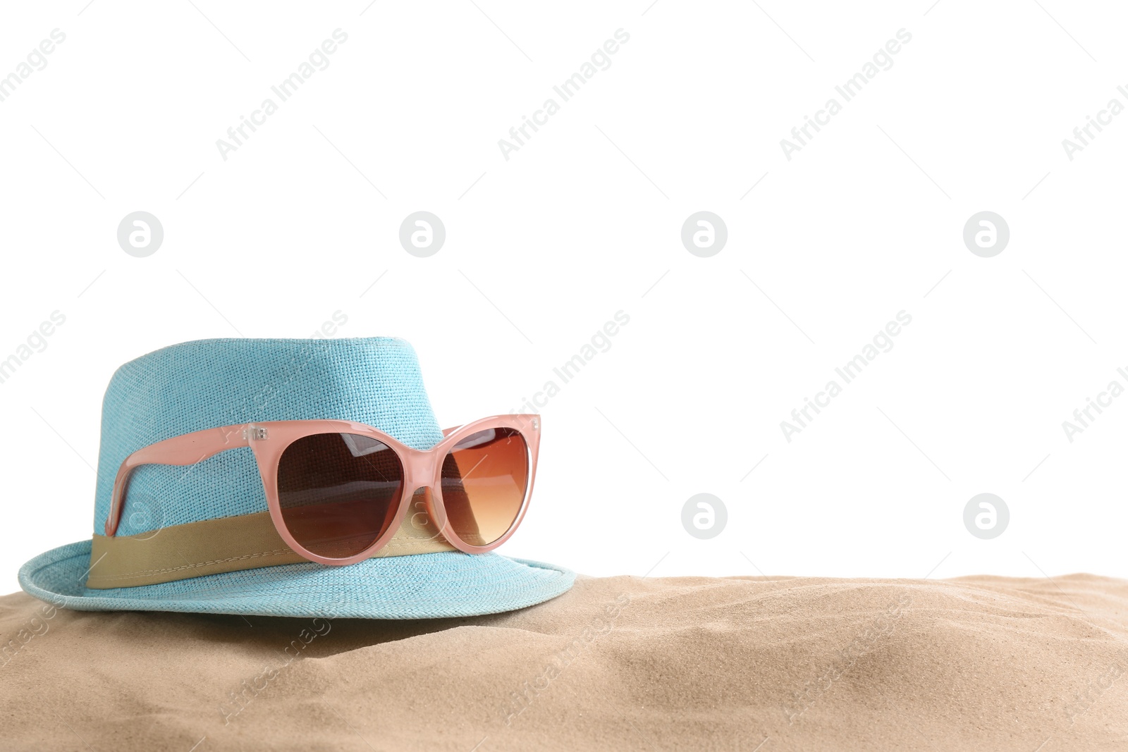 Photo of Composition with hat, beach sand and sunglasses on white background, space for text