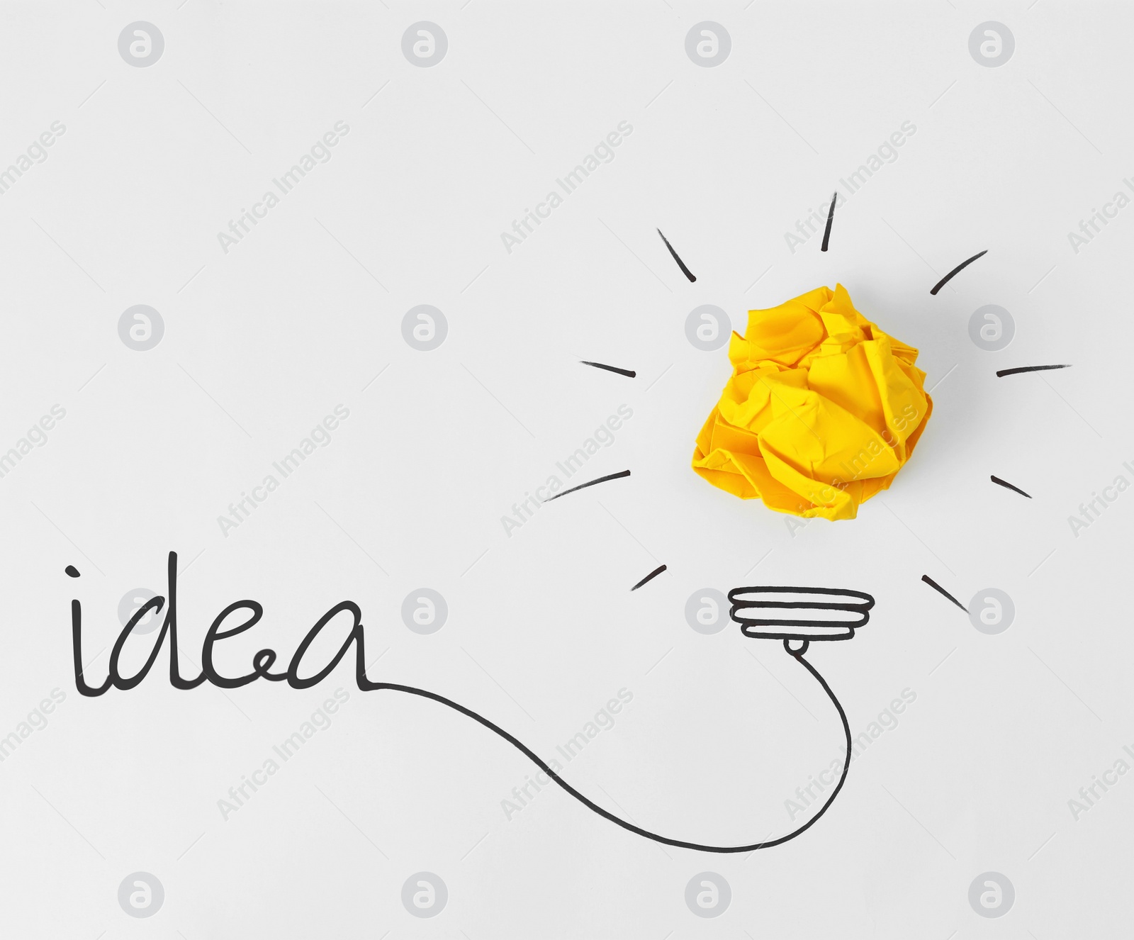 Image of Idea concept. Composition with crumpled paper ball and drawing of lamp bulb on white background, top view