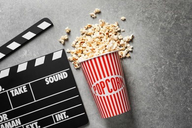 Clapperboard and popcorn on table