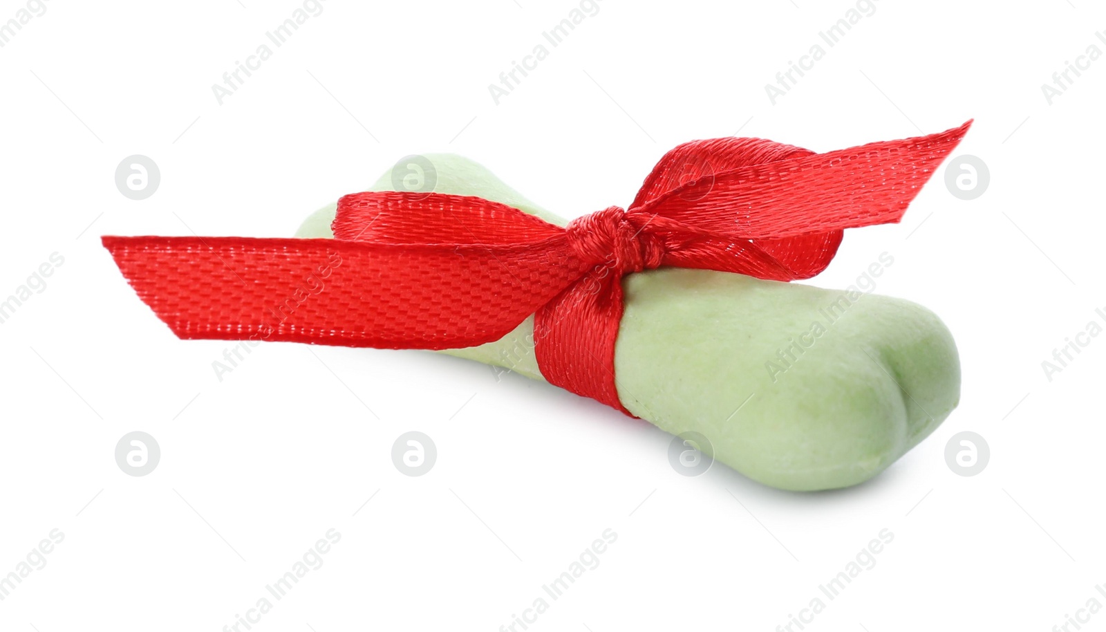 Photo of Bone shaped dog cookie with red bow isolated on white