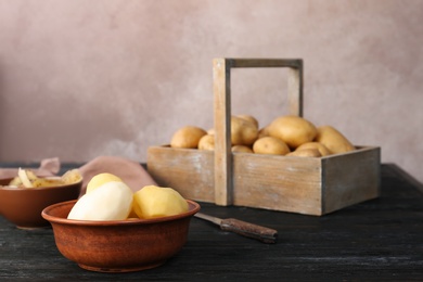 Photo of Composition with fresh organic potatoes on table