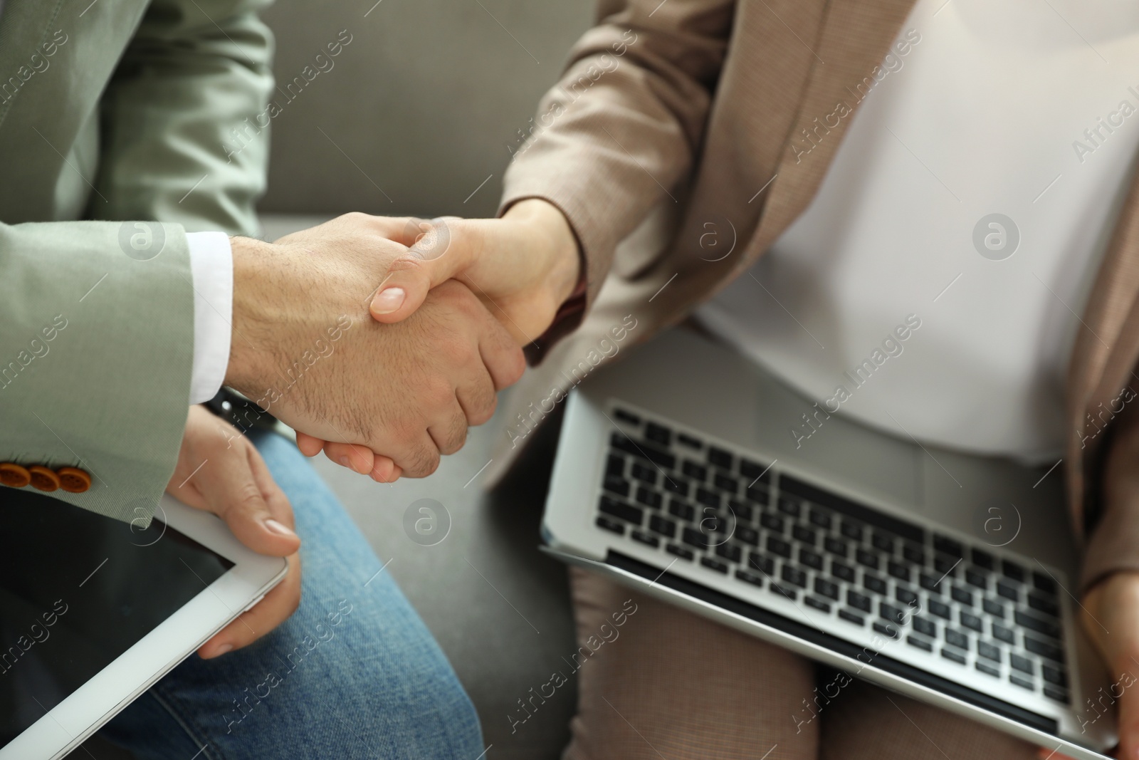 Photo of Business partners shaking hands after meeting, closeup