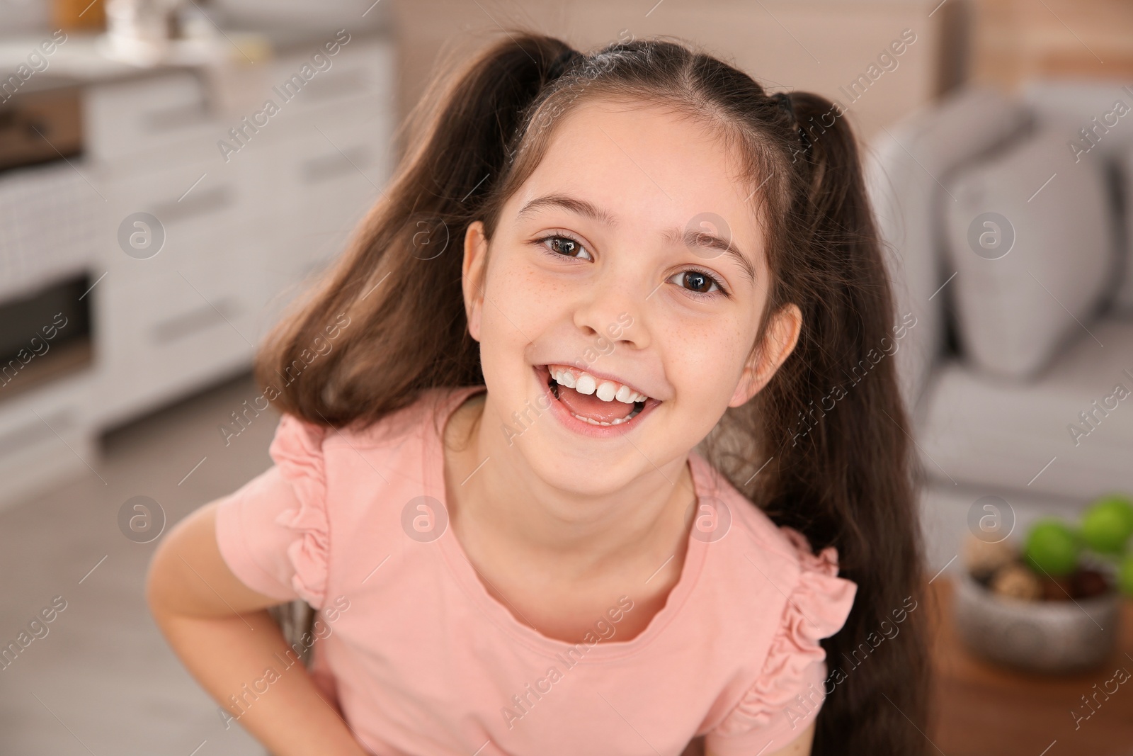 Photo of Portrait of little girl laughing at home