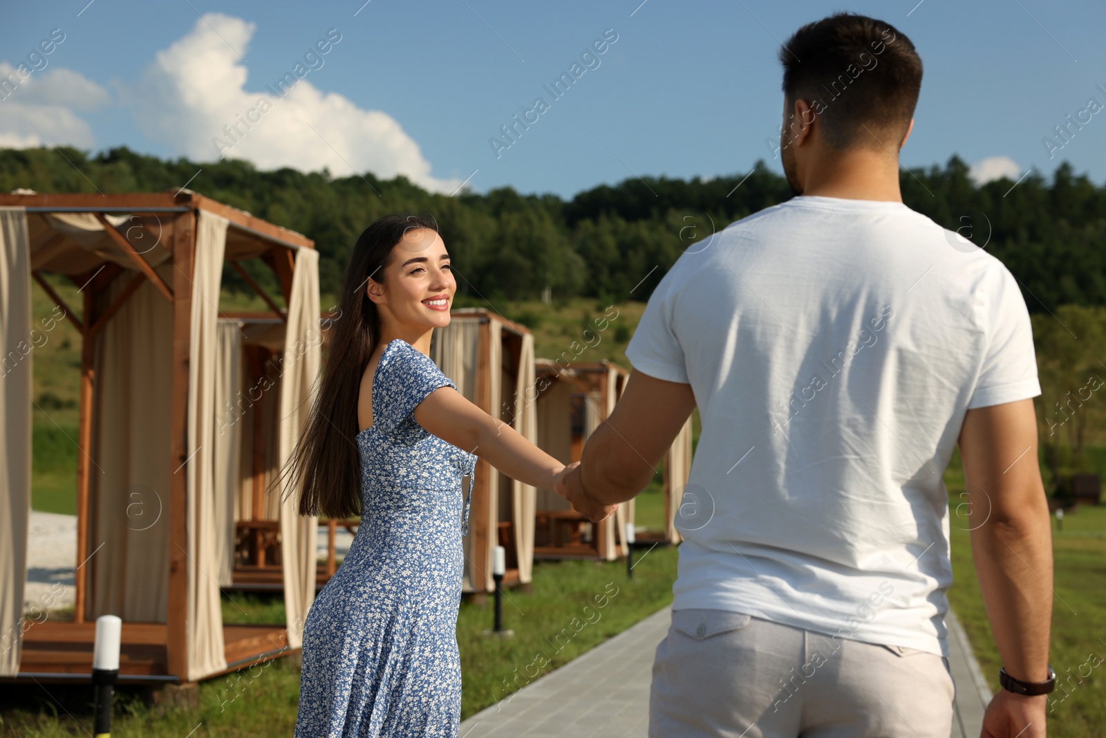 Photo of Romantic date. Beautiful couple walking on sunny day outdoors