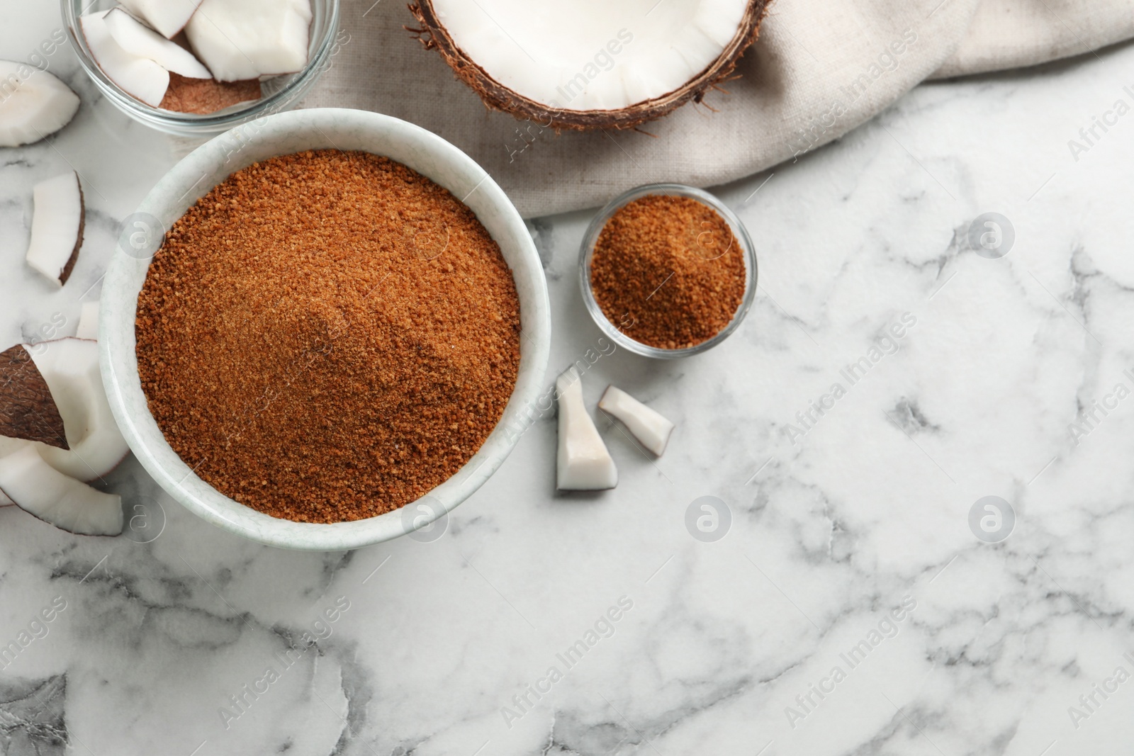 Photo of Flat lay composition with natural coconut sugar on white marble table, space for text