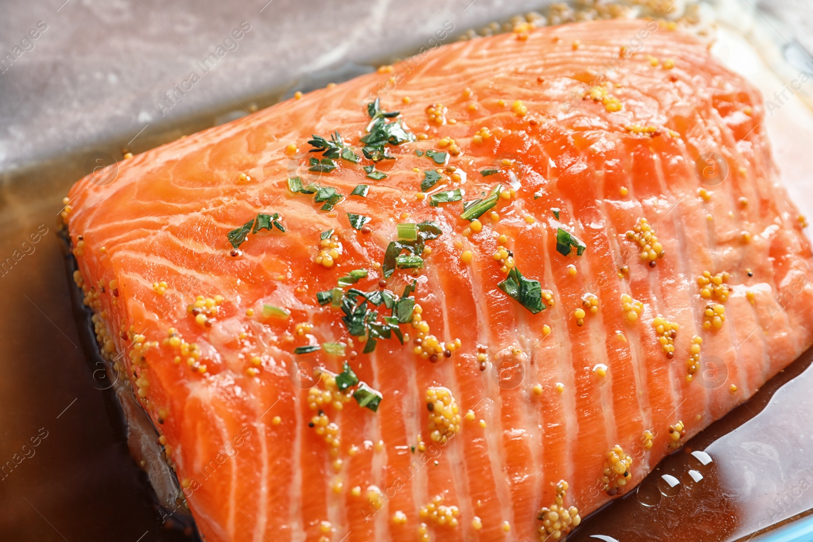 Photo of Raw salmon fillet with marinade, closeup