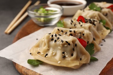 Photo of Delicious gyoza (asian dumplings) with sesame seeds on table, closeup