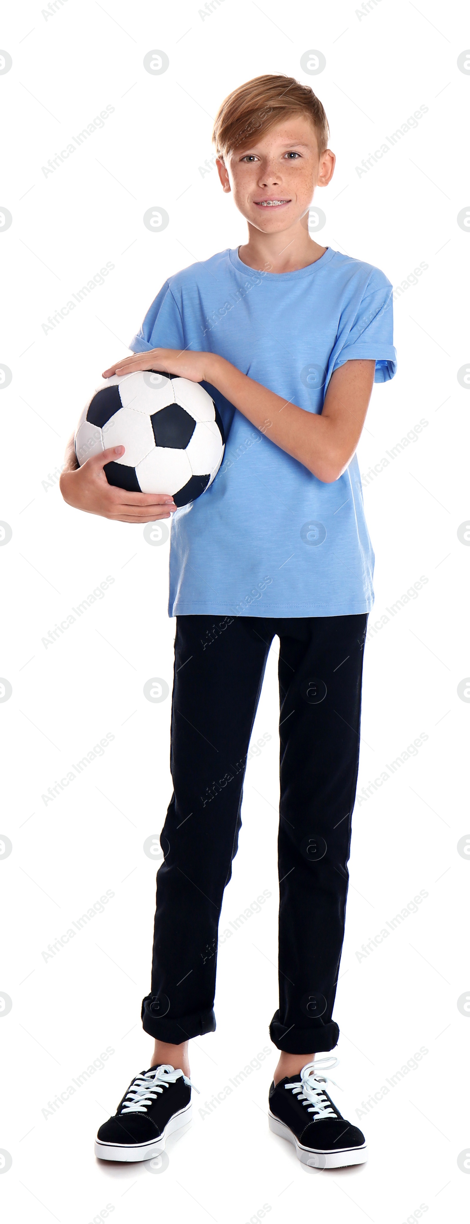 Photo of Portrait of young boy holding soccer ball on white background