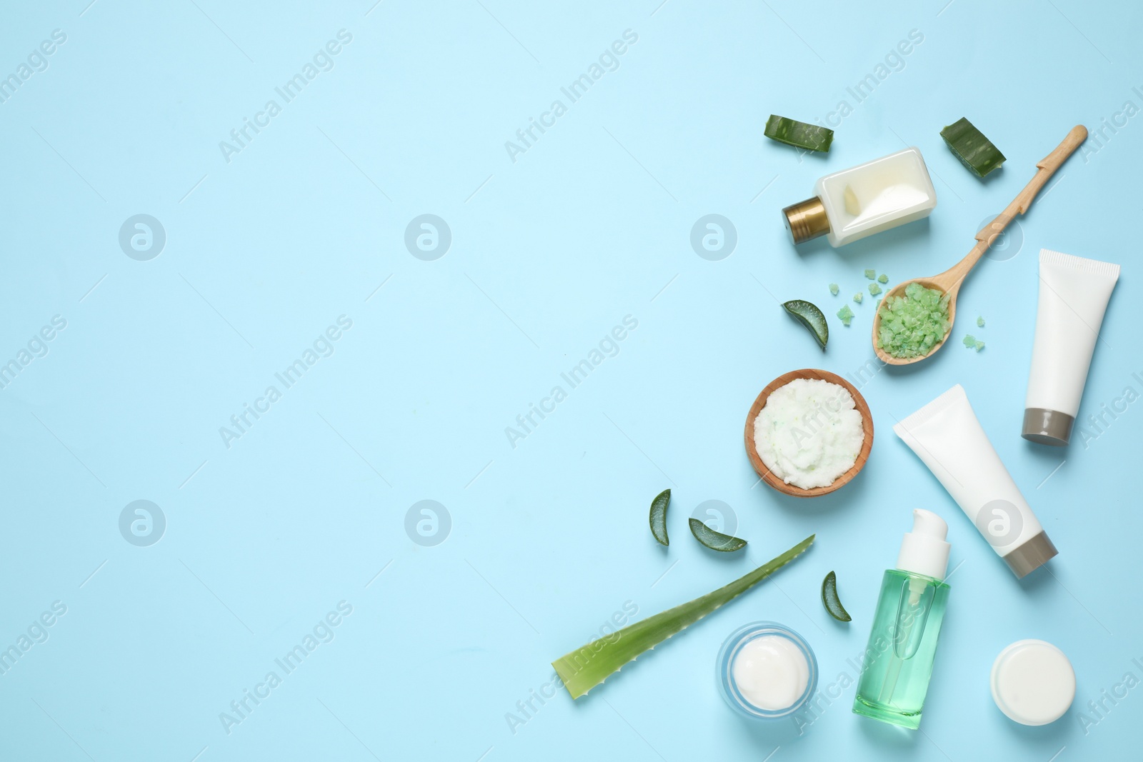 Photo of Flat lay composition with aloe vera and cosmetic products on light blue background. Space for text