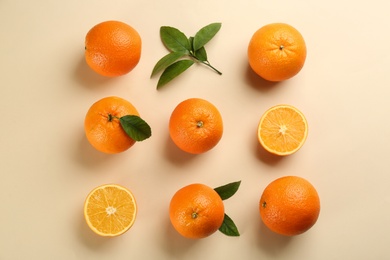 Delicious oranges on beige background, flat lay