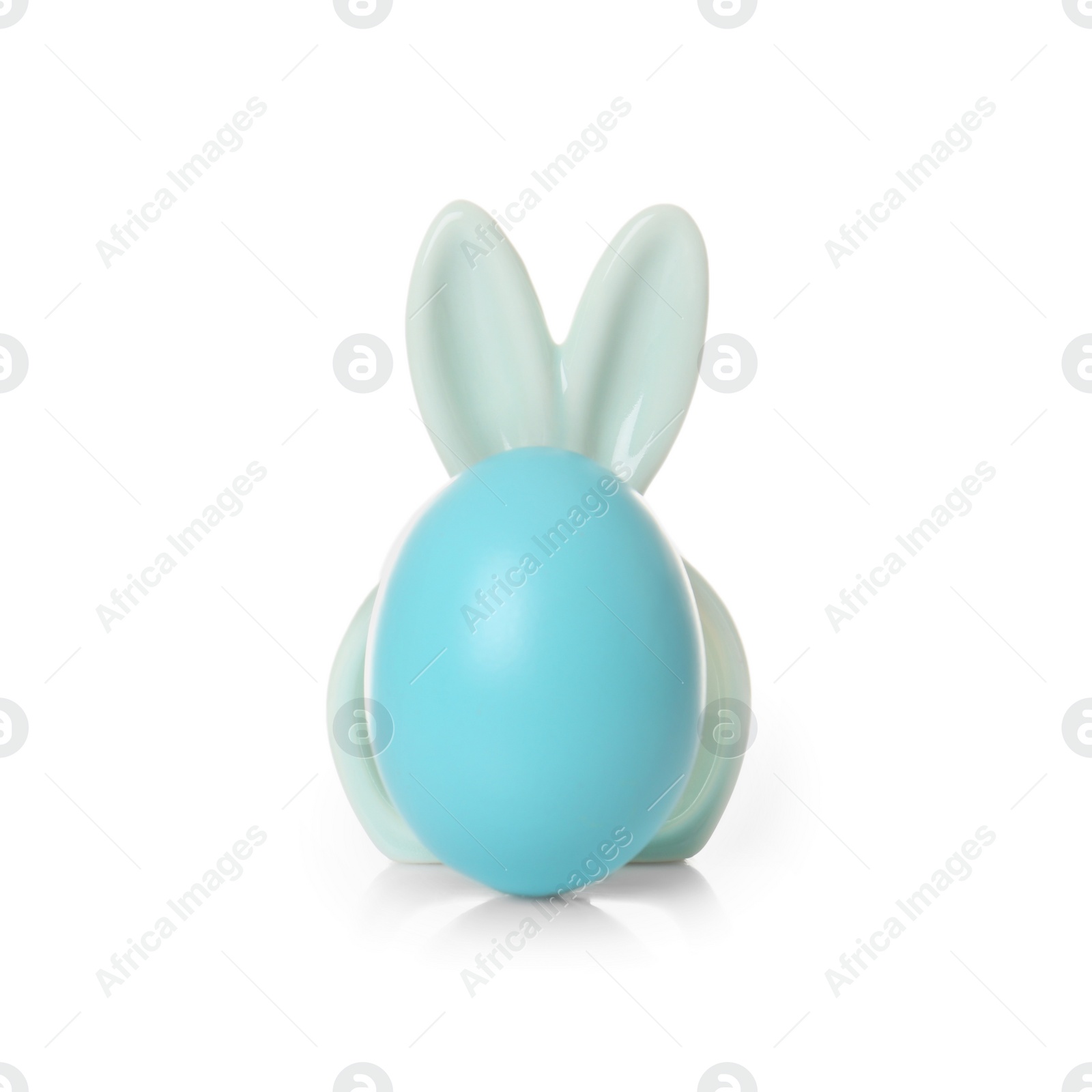 Photo of Cute dyed egg with decorative Easter bunny ears on white background