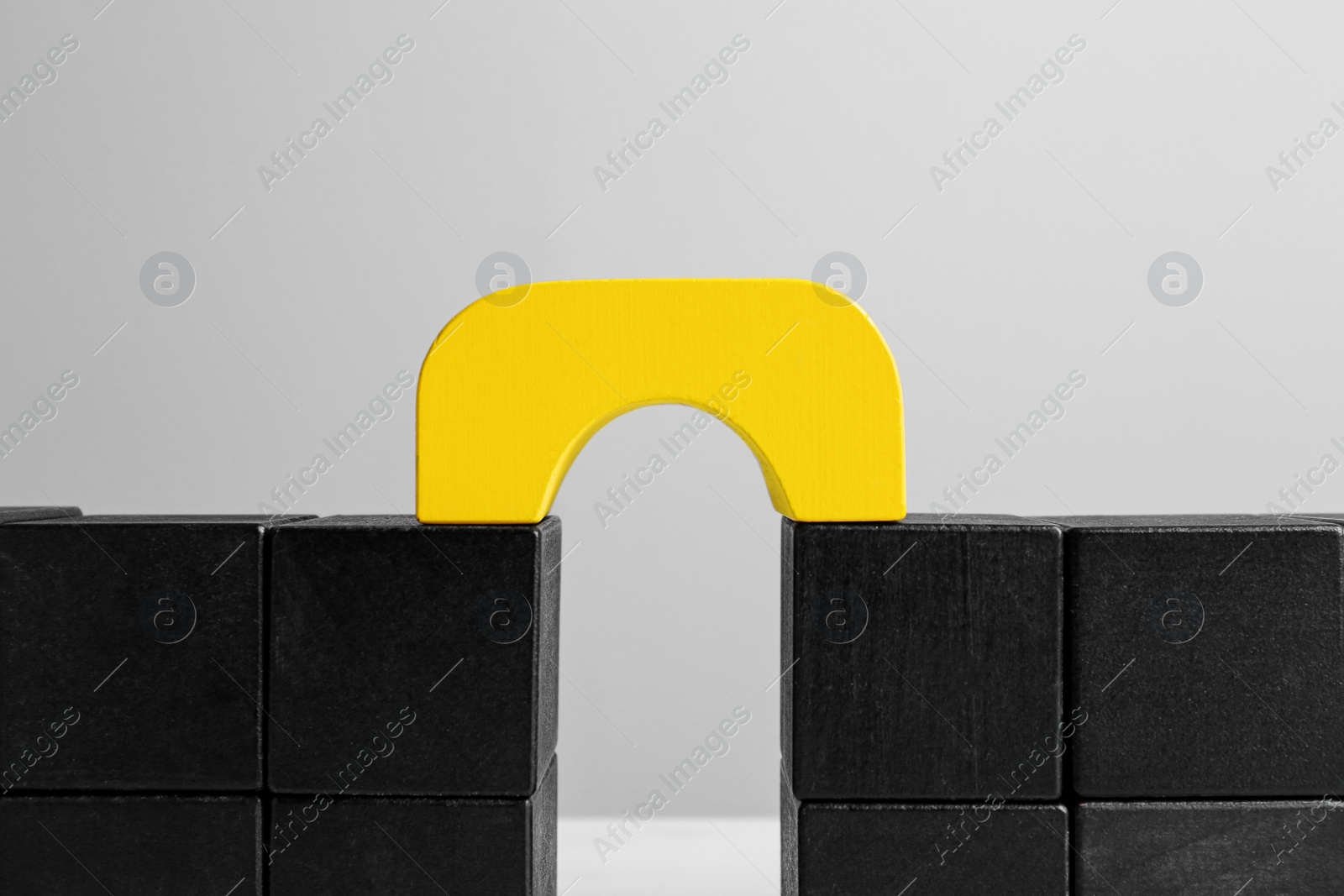 Photo of Bridge made of blocks on grey background, closeup. Connection, relationships and deal concept