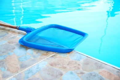 Photo of New scoop net near outdoor pool, closeup