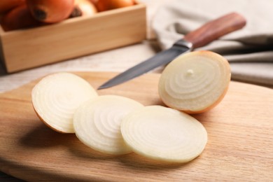 Photo of Sliced fresh onion on wooden table, closeup