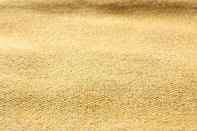 Photo of Texture of soft yellow fabric as background, closeup