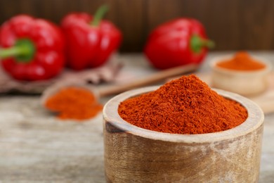 Photo of Bowl with aromatic paprika powder on table, closeup. Space for text