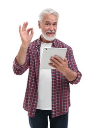 Man with tablet showing ok gesture on white background