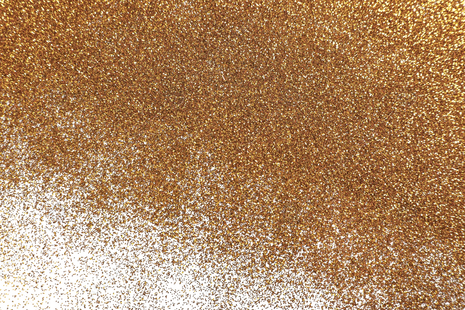 Photo of Shiny golden glitter on white background, top view