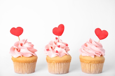 Photo of Row of tasty cupcakes for Valentine's Day on white background