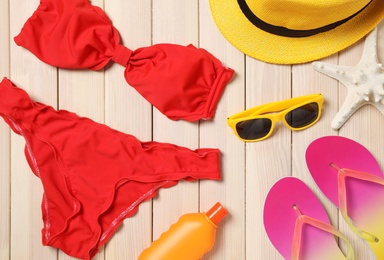 Flat lay composition with beach objects on wooden background