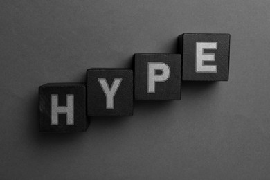 Image of Word Hype of black cubes with letters on grey background, top view