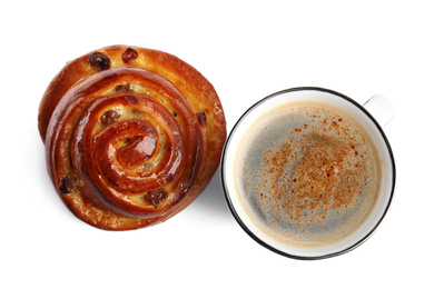 Delicious coffee and bun on white background, top view. Sweet pastries