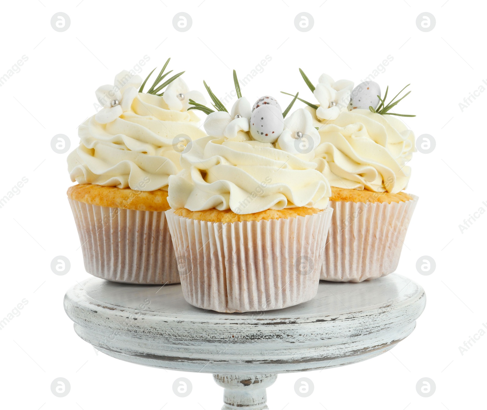 Photo of Tasty Easter cupcakes with vanilla cream isolated on white