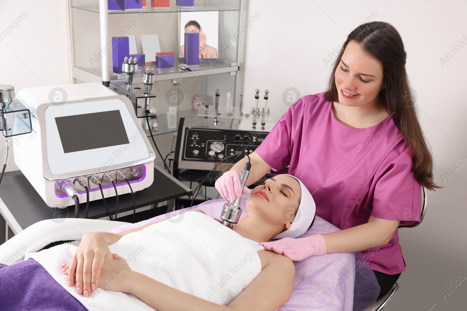 Photo of Young woman undergoing cosmetic procedure in beauty salon. Microcurrent therapy