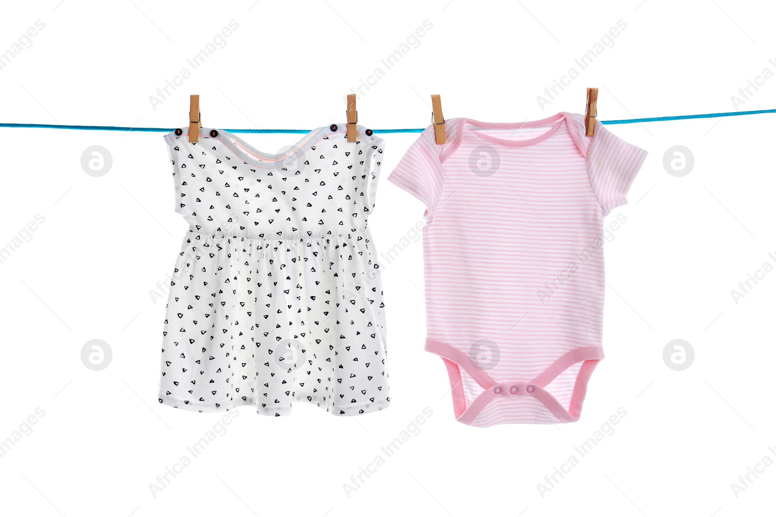 Photo of Baby clothes on laundry line against white background