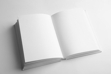 Photo of Open book with blank pages on white background. Mock up for design
