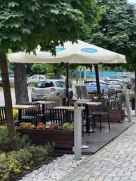 Photo of WARSAW, POLAND - JULY 11, 2022: View of outdoor cafe terrace on city street