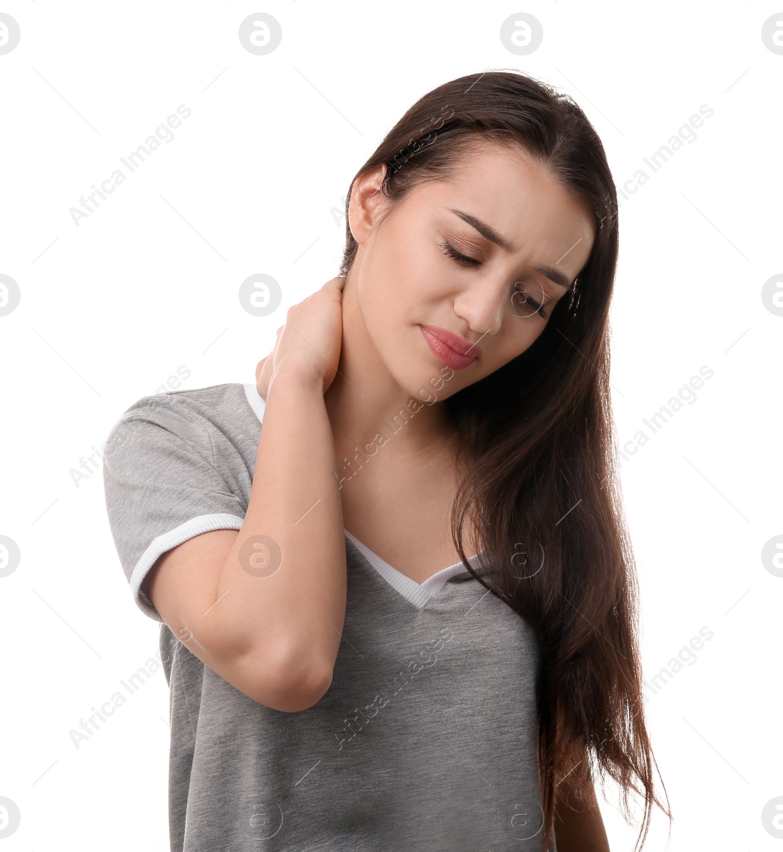 Photo of Young woman suffering from pain in neck on white background