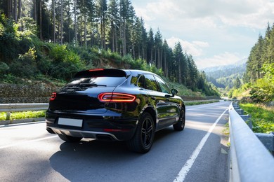 Photo of Picturesque view of asphalt road with modern car