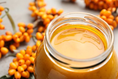 Photo of Delicious sea buckthorn jam in jar, closeup