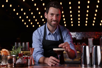 Photo of Bartender preparing Espresso Martini in bar. Alcohol cocktail